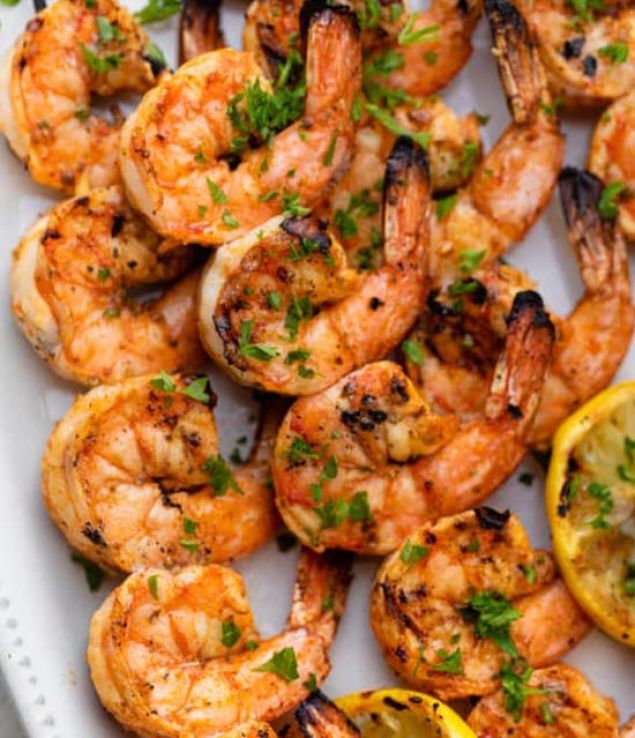 Broiled shrimp skewers with zhoug on quinoa tabbouleh and hummus